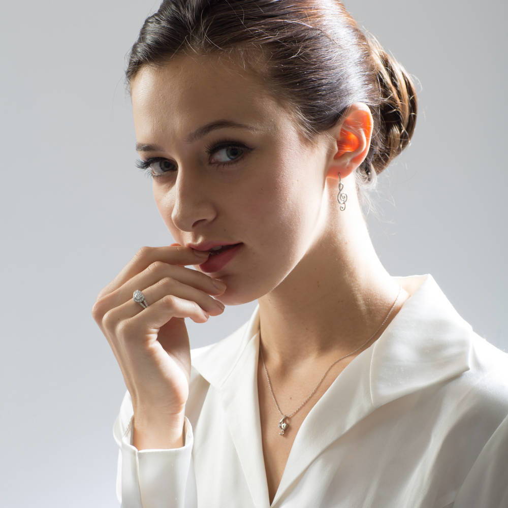 Model wearing Treble Clef Music Note Fish Hook Earrings in Sterling Silver, 7 of 8