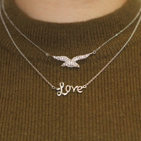 Model Wearing Bird Pendant Necklace, Love Pendant Necklace