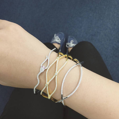 Model Wearing Criss Cross Cuff, Snake Bangle, Woven Cuff