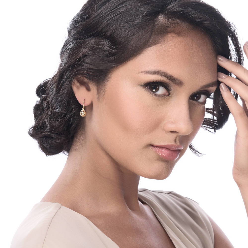 Model wearing Ball Bead Fish Hook Earrings in Sterling Silver, Yellow Gold Flashed