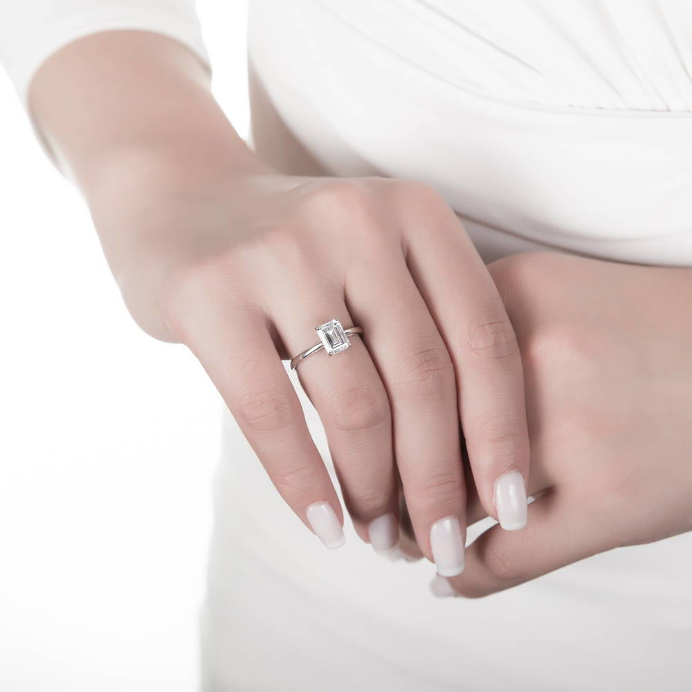 Model wearing Solitaire 2.1ct Emerald Cut CZ Ring Set in Sterling Silver, 10 of 12