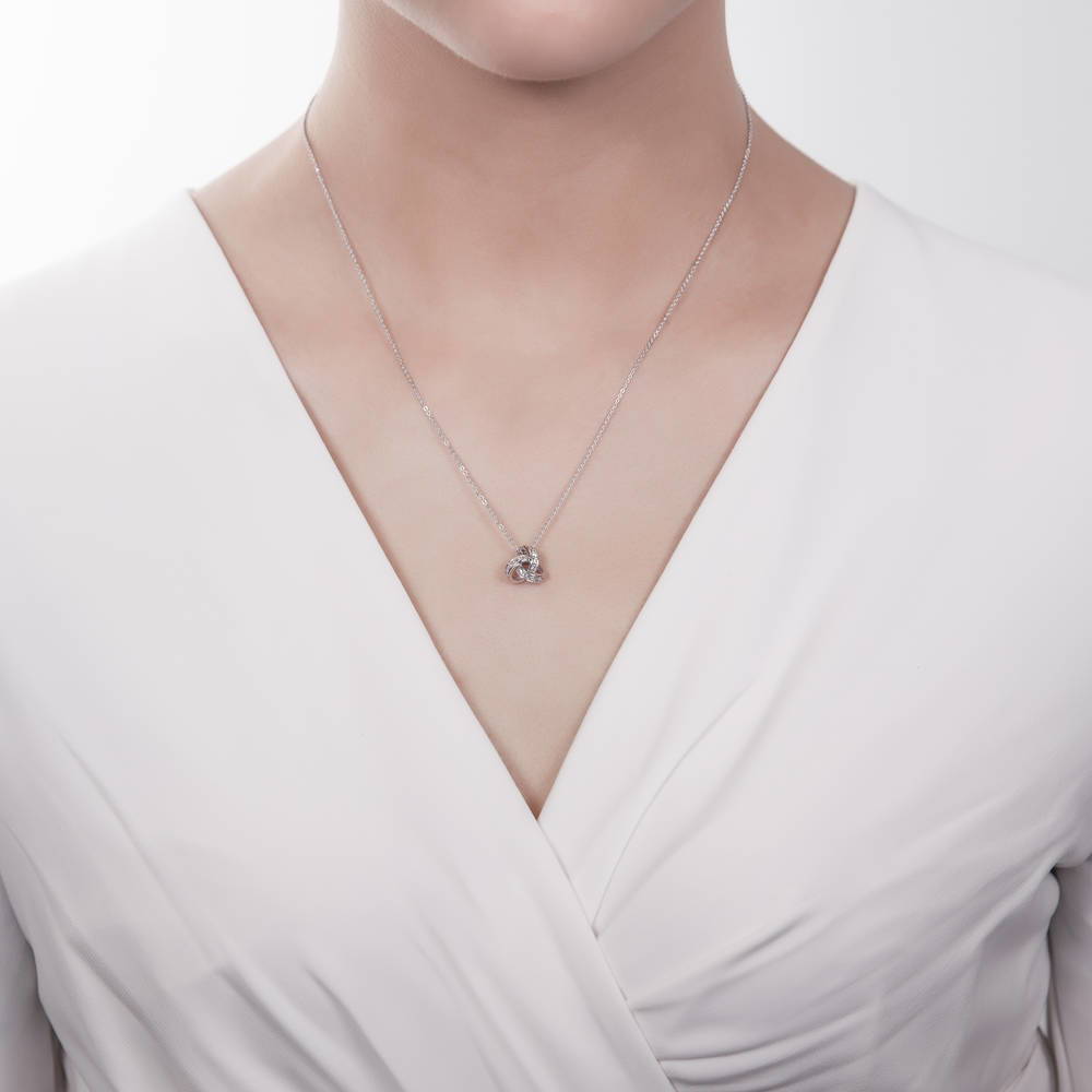 Model wearing Love Knot CZ Necklace and Earrings in Sterling Silver, 11 of 15