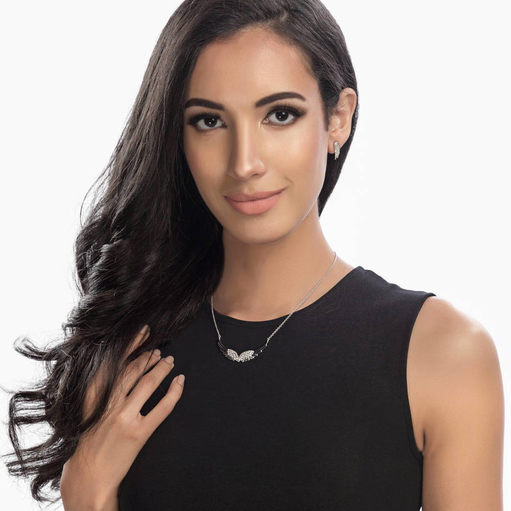 Model wearing Angel Wings CZ Stud Earrings in Sterling Silver, 2 of 4