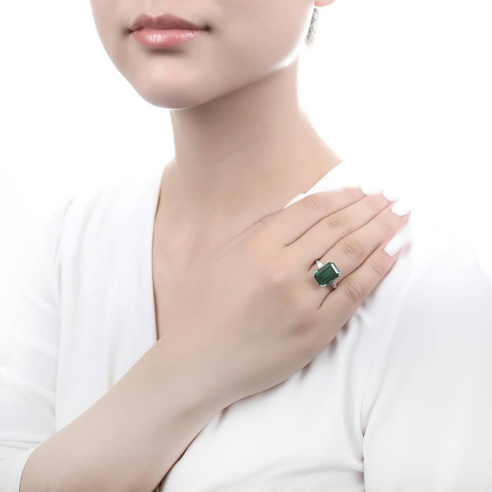 Model wearing Solitaire Emerald-Green Emerald Cut CZ Ring in Sterling Silver, 2 of 11
