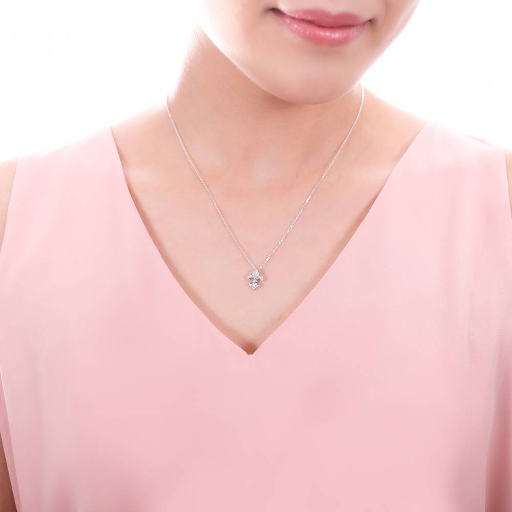 Model wearing Fleur De Lis CZ Necklace and Earrings Set in Sterling Silver