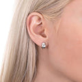 Model wearing Dome Mini Huggie Earrings in Sterling Silver 0.5 inch, Rhodium Plated