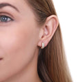 Model wearing Dome CZ Mini Huggie Earrings in Sterling Silver 0.5 inch, Yellow Gold Flashed