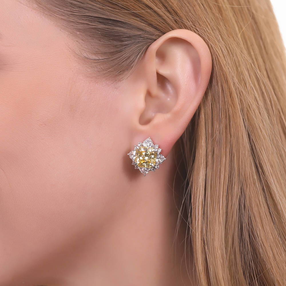 Model wearing Halo Canary Cushion CZ Omega Back Stud Earrings in Sterling Silver, 2 of 7