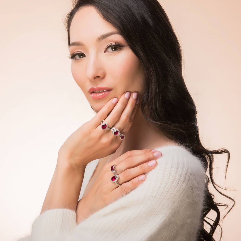 Model wearing 3-Stone 3ct Simulated Ruby Cushion CZ Ring in Sterling Silver, 7 of 10