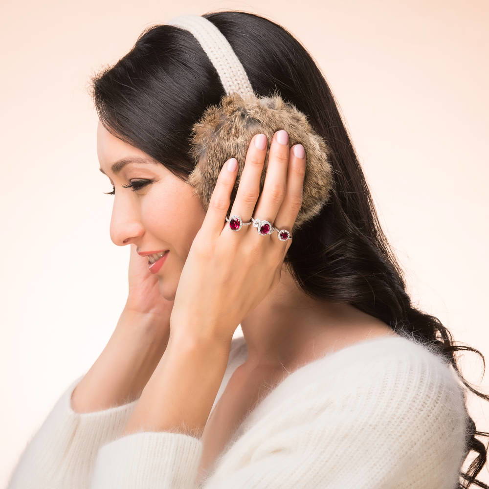 Model wearing Halo Simulated Ruby Oval CZ Ring in Sterling Silver