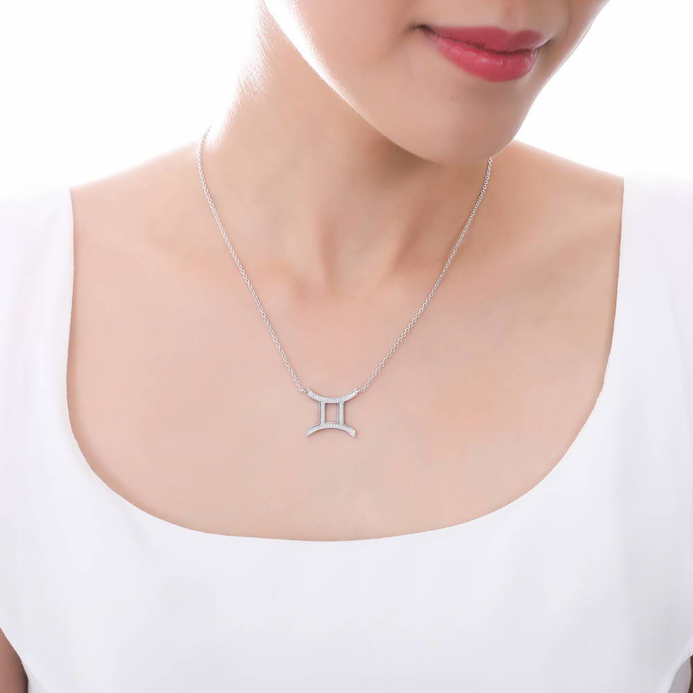 Model wearing Zodiac Gemini CZ Pendant Necklace in Sterling Silver, 2 of 6