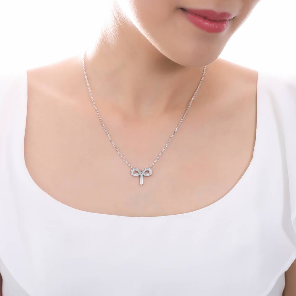 Model wearing Zodiac Aries CZ Pendant Necklace in Sterling Silver, 2 of 6