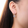 Model wearing Solitaire CZ Leverback Earrings in Sterling Silver, Rhodium Plated, 7mm, Default Title