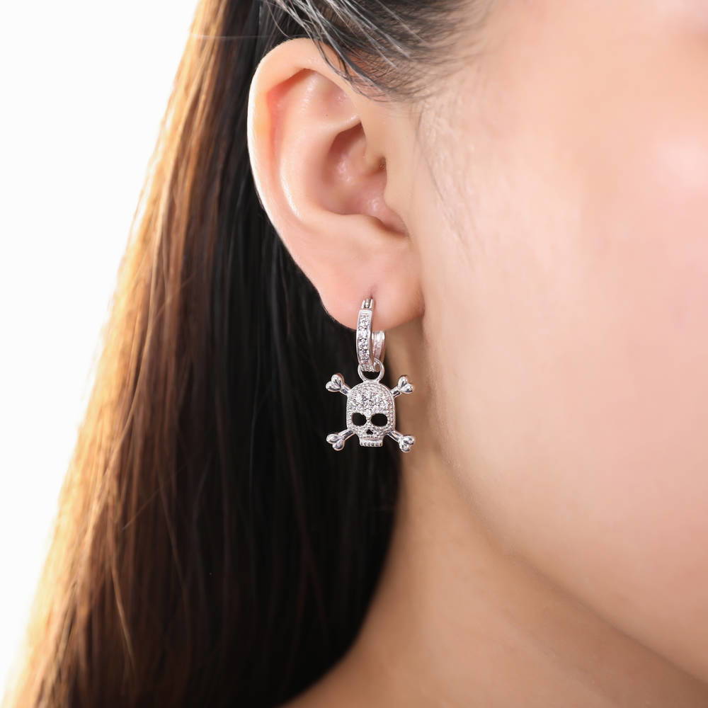 Model wearing Skull Bones CZ Dangle Earrings in Sterling Silver, 4 of 7