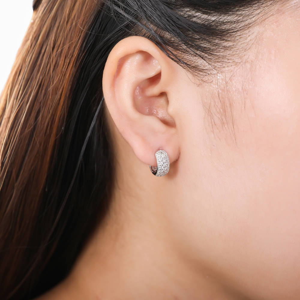 Model wearing Dome CZ Mini Huggie Earrings in Sterling Silver 0.5 inch, Yellow Gold Flashed