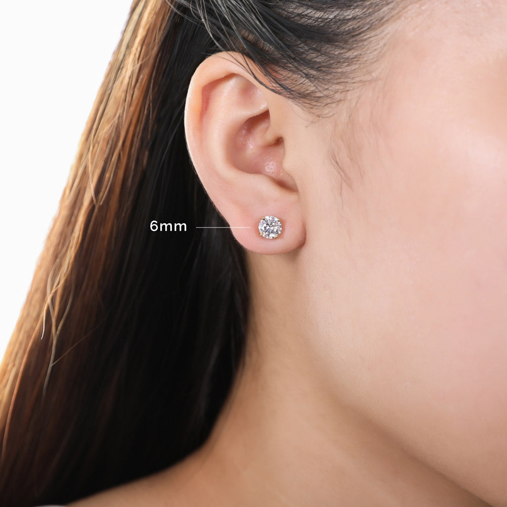 Model wearing Solitaire Round CZ Stud Earrings in Gold Flashed Sterling Silver, 12 of 14