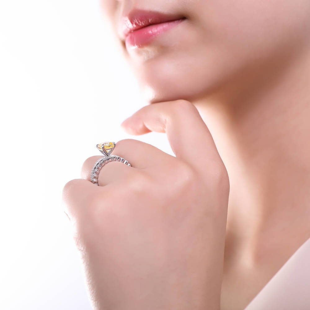 Model wearing Solitaire 3ct Canary Yellow Cushion CZ Ring in Sterling Silver, 11 of 19