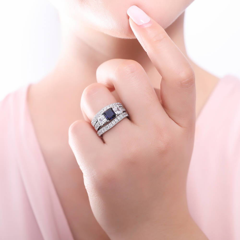 Model wearing 3-Stone Simulated Blue Sapphire Princess CZ Ring Set in Sterling Silver, 2 of 9