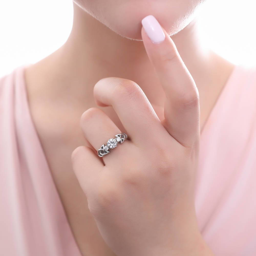Model wearing 3-Stone Celtic Knot Round CZ Ring in Sterling Silver, 5 of 9