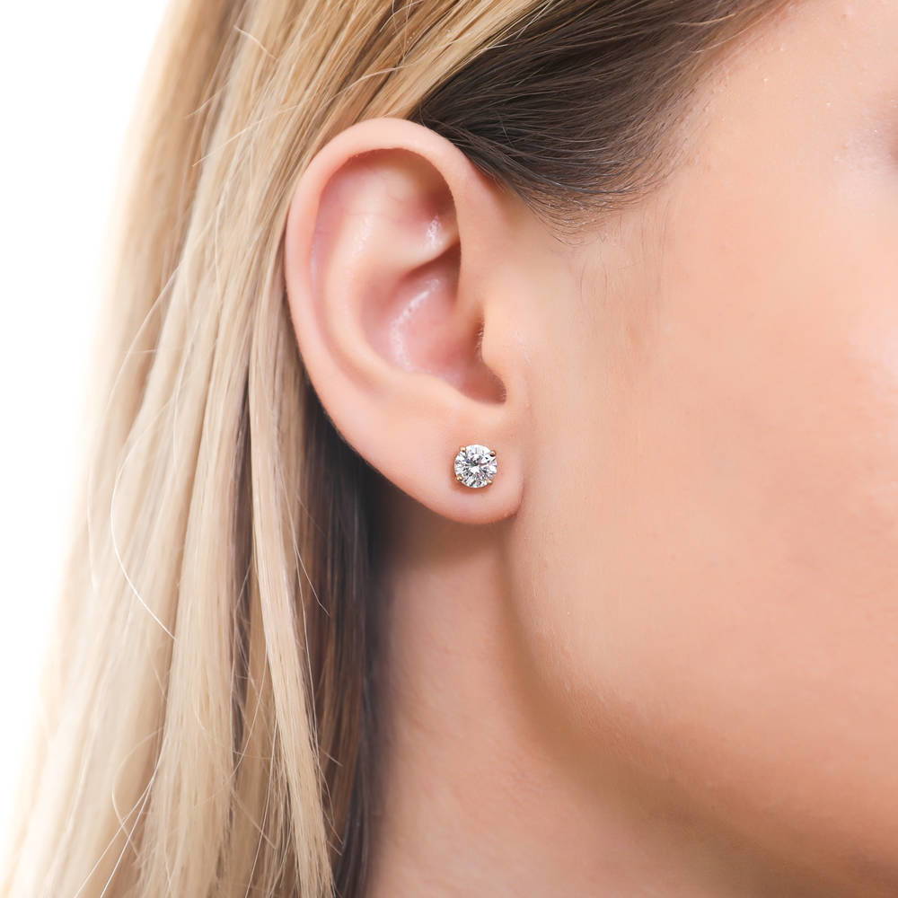 Model wearing Solitaire 1.6ct Round CZ Stud Earrings in Gold Flashed Sterling Silver, 2 of 4