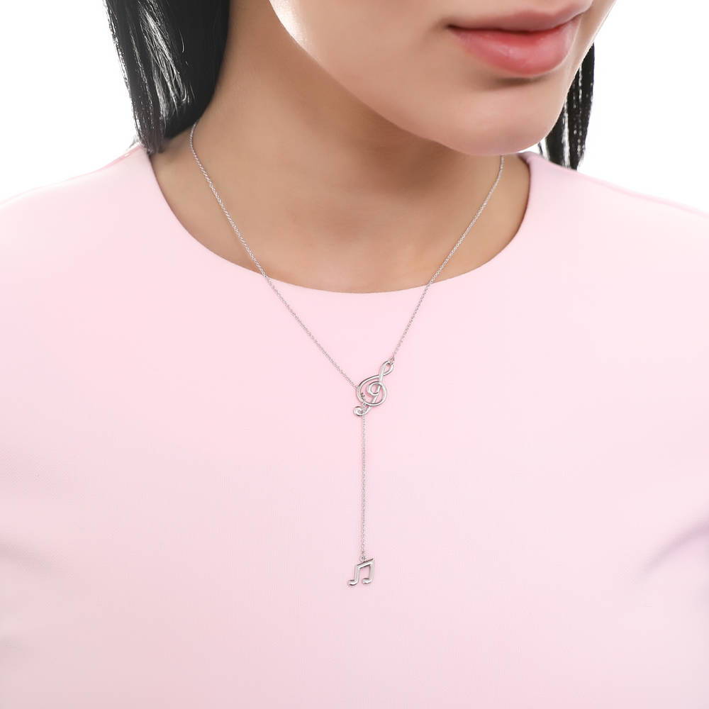 Model wearing Treble Clef Music Note Lariat Necklace in Sterling Silver, 5 of 9