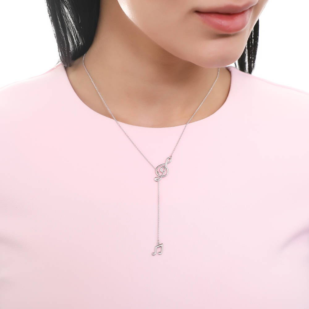 Model wearing Treble Clef Music Note Lariat Necklace in Sterling Silver, 6 of 10