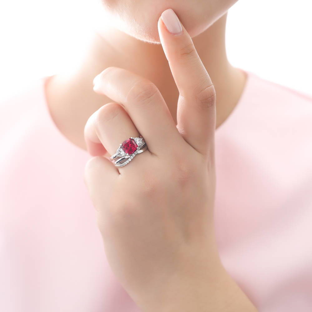 Model wearing 3-Stone Simulated Ruby Cushion CZ Ring Set in Sterling Silver, 2 of 11
