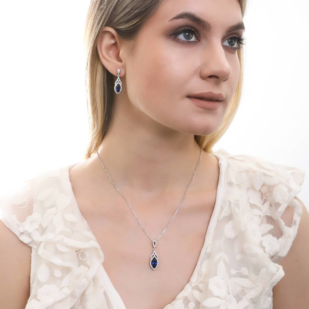 Model wearing Halo Art Deco Simulated Blue Sapphire CZ Set in Sterling Silver, 2 of 9