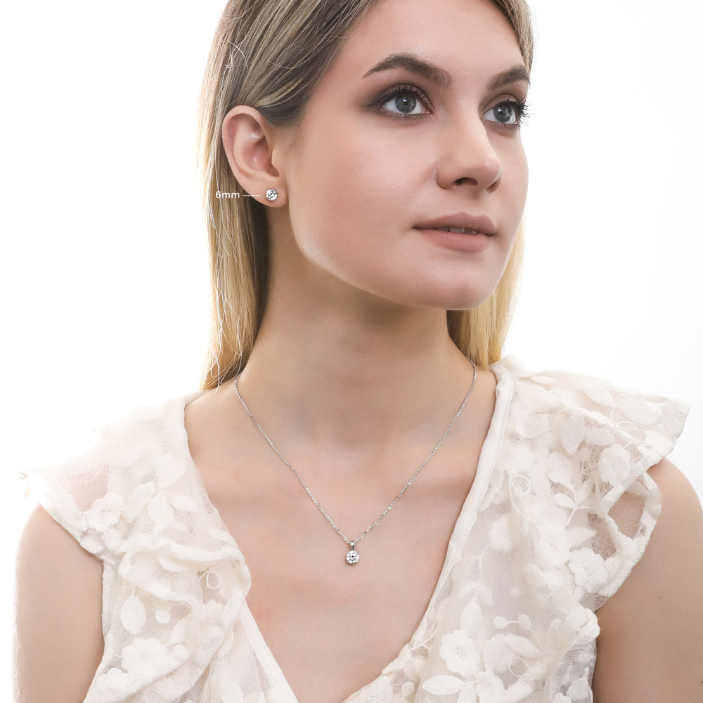 Model wearing Solitaire Round CZ Stud Earrings in Sterling Silver, 12 of 14