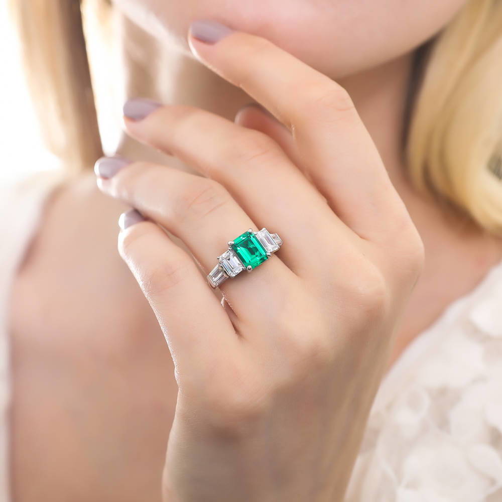 Model wearing 3-Stone Simulated Emerald Emerald Cut CZ Ring in Sterling Silver, 2 of 8