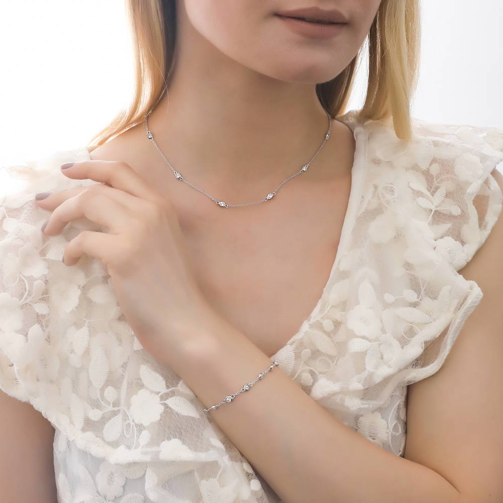 Model wearing Solitaire 0.45ct Round CZ Pendant Station Necklace in Sterling Silver, 2 of 11