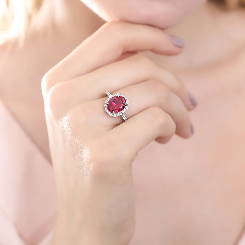 Model wearing Halo Simulated Ruby Oval CZ Ring in Sterling Silver, 3 of 11