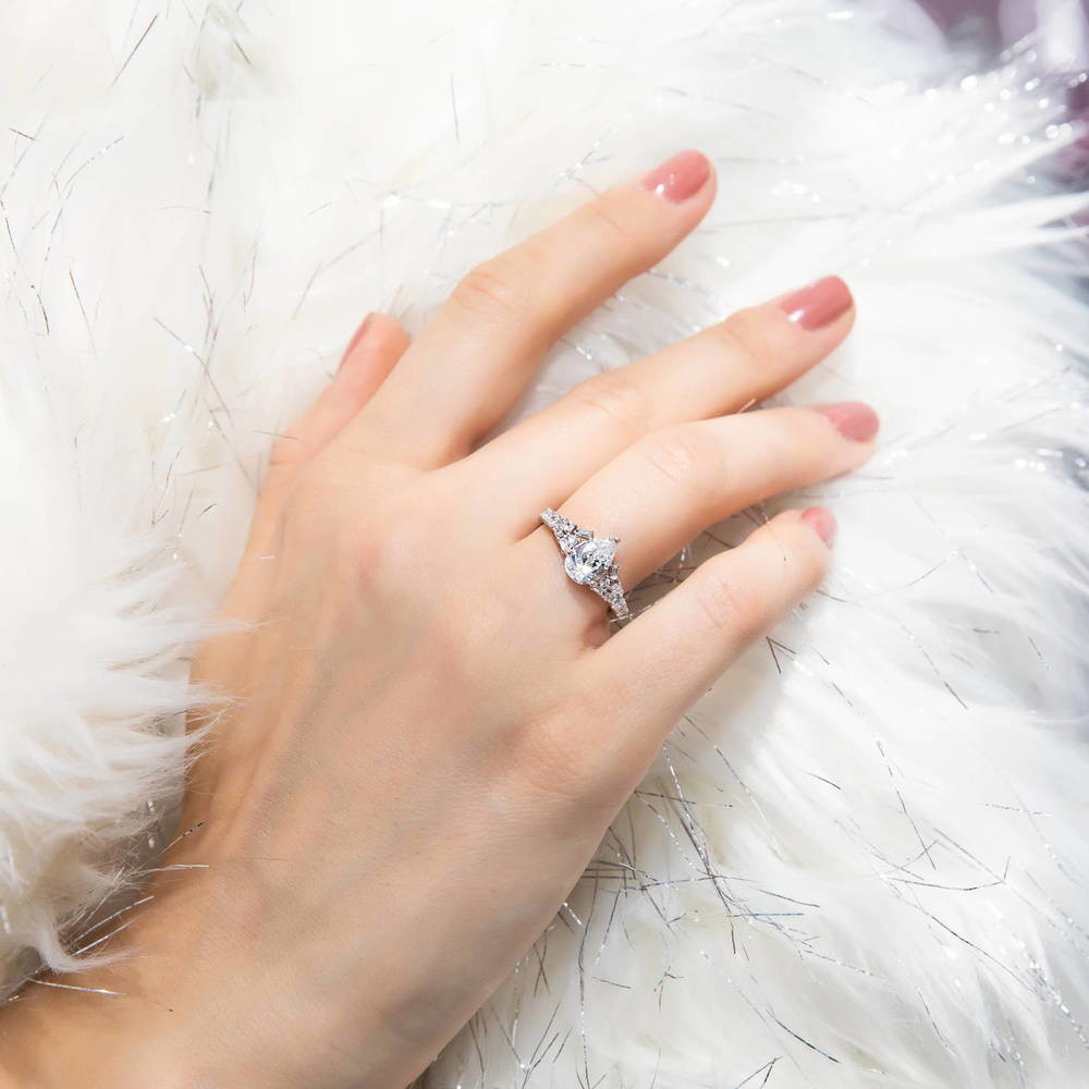 Model wearing Solitaire 1.3ct Pear CZ Ring in Sterling Silver, 2 of 7