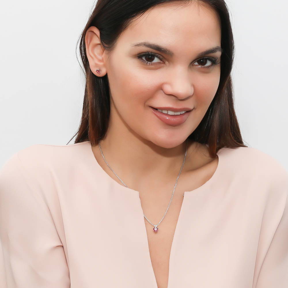 Model wearing Solitaire Heart Red Heart CZ Stud Earrings in Sterling Silver, 3 of 5