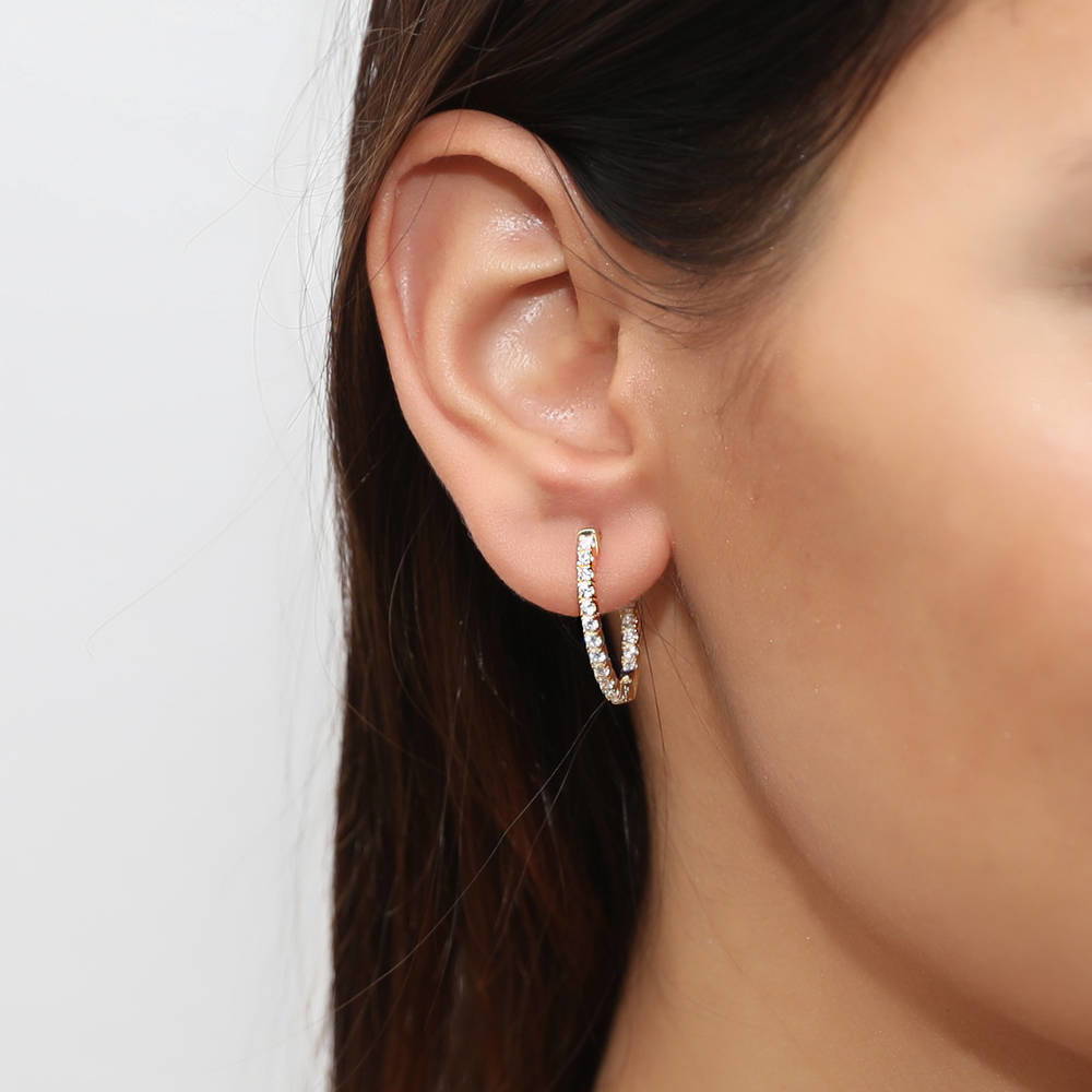 Model wearing Oval CZ Medium Inside-Out Hoop Earrings in Sterling Silver 0.84 inch, 7 of 16