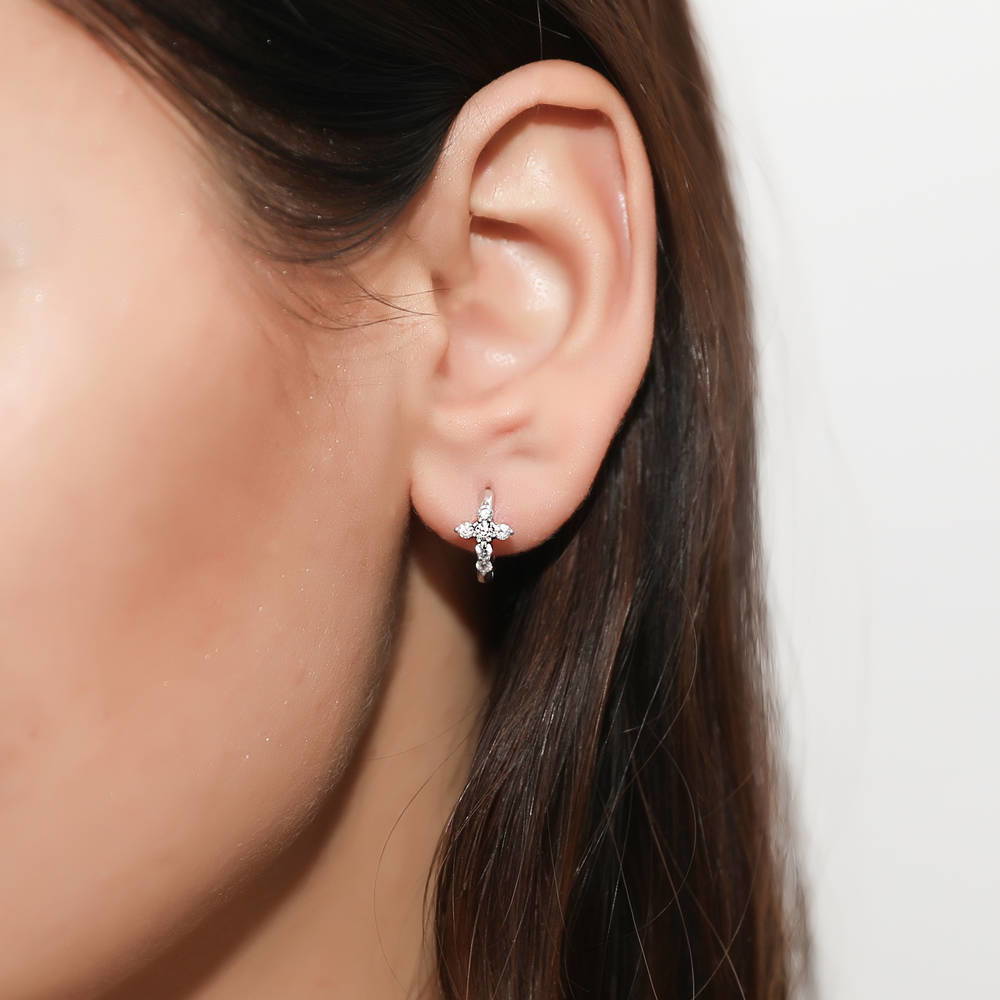Model wearing Cross CZ Mini Huggie Earrings in Sterling Silver 0.5 inch, Rhodium Plated