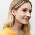 Model wearing Dome CZ Mini Huggie Earrings in Sterling Silver 0.5 inch, Yellow Gold Flashed