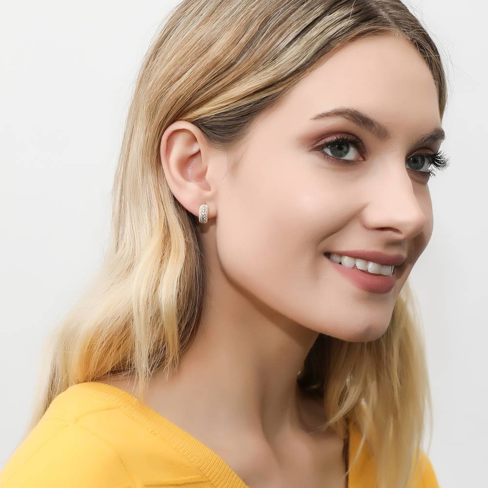 Model wearing Dome CZ Mini Huggie Earrings in Sterling Silver 0.5 inch, Yellow Gold Flashed