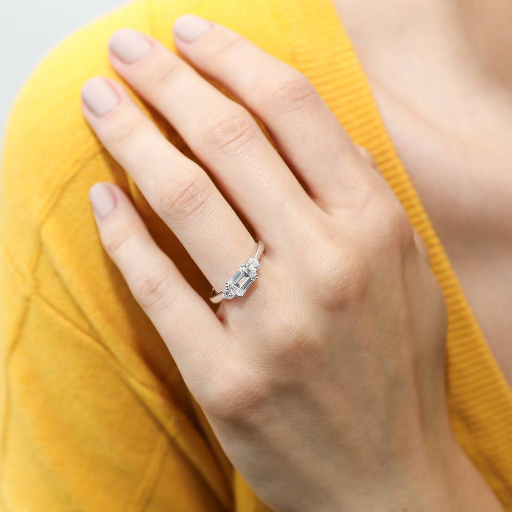 Model wearing 3-Stone East-West 1ct Emerald Cut CZ Ring Set in Sterling Silver, 9 of 13