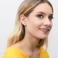 Model wearing Dome CZ Mini Huggie Earrings in Sterling Silver 0.5 inch, Yellow Gold Flashed