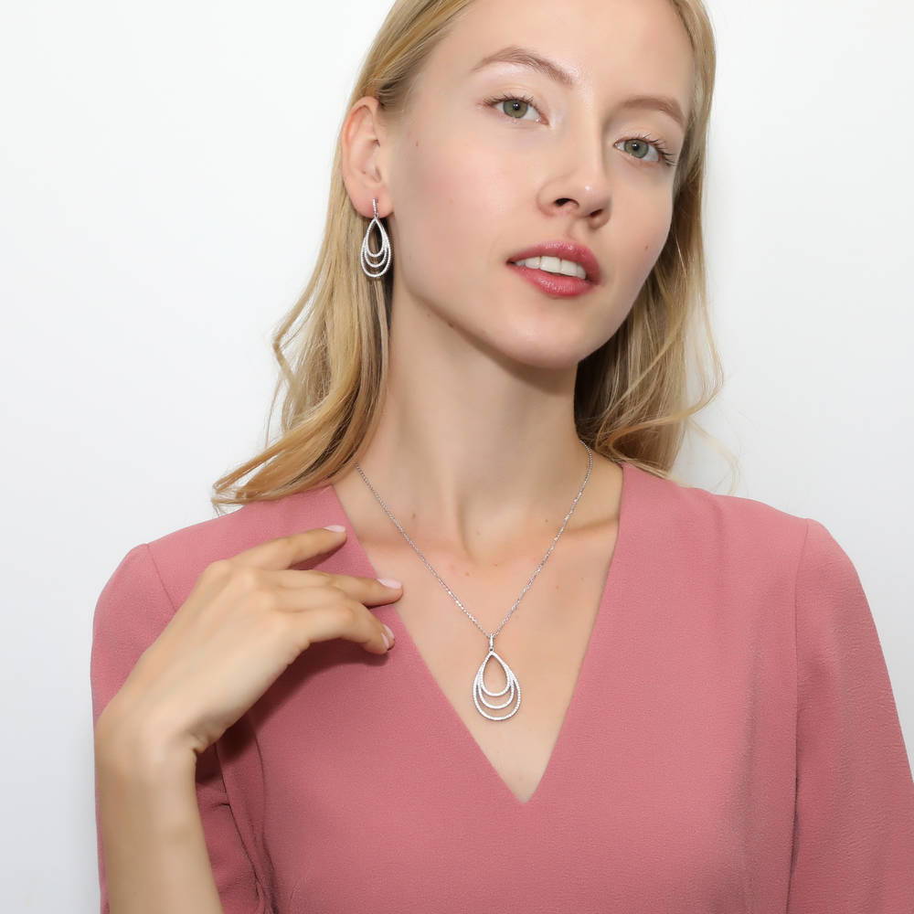 Model wearing Teardrop CZ Dangle Earrings in Sterling Silver, 4 of 5