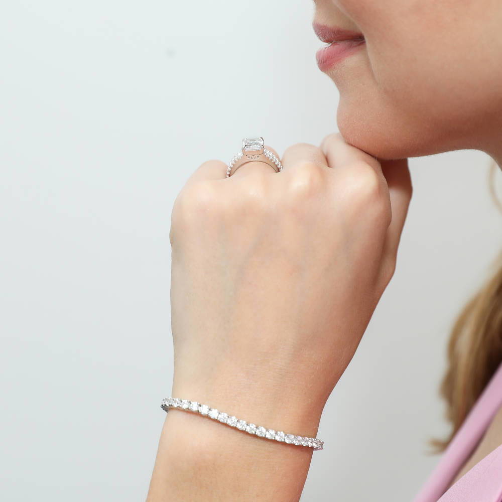 Model wearing Solitaire Emerald Cut CZ Split Shank Ring in Sterling Silver, 2 of 9