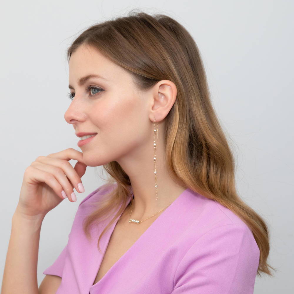 Model wearing Bead Imitation Pearl Threader Earrings in Gold Flashed Sterling Silver, 3 of 4