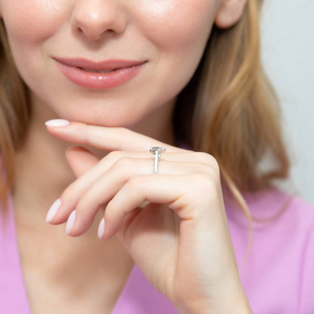 Model wearing Solitaire 0.8ct Pear CZ Ring in Sterling Silver, 7 of 9