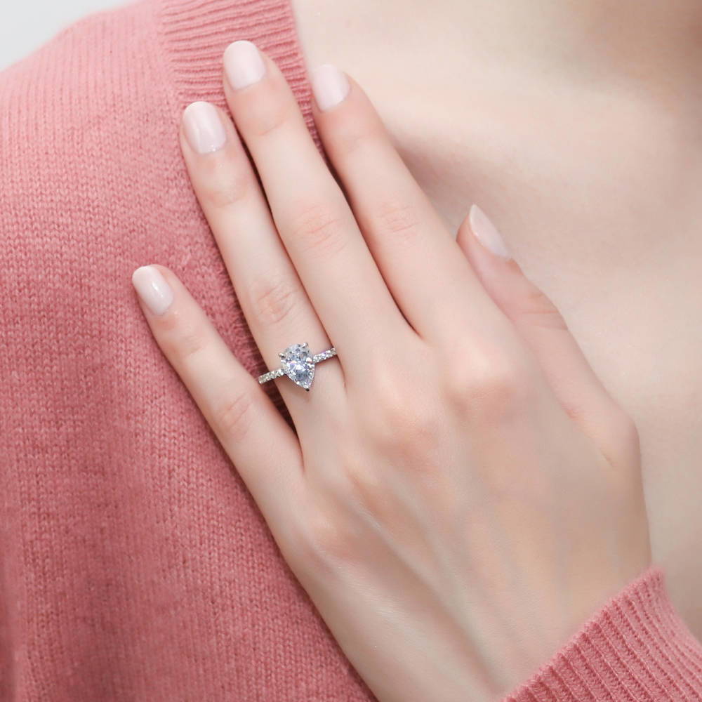 Model wearing Solitaire Hidden Halo 1.8ct Pear CZ Ring in Sterling Silver, 2 of 8