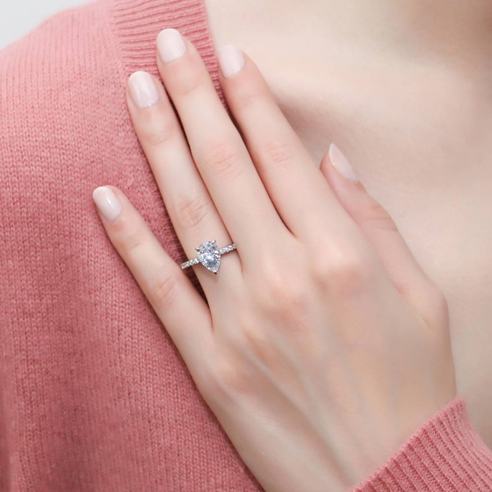 Model wearing Solitaire Hidden Halo 1.8ct Pear CZ Ring Set in Sterling Silver, 9 of 13
