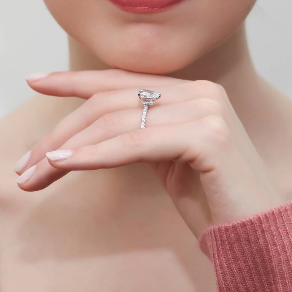 Model wearing Solitaire Hidden Halo 1.8ct Pear CZ Ring Set in Sterling Silver, 11 of 13