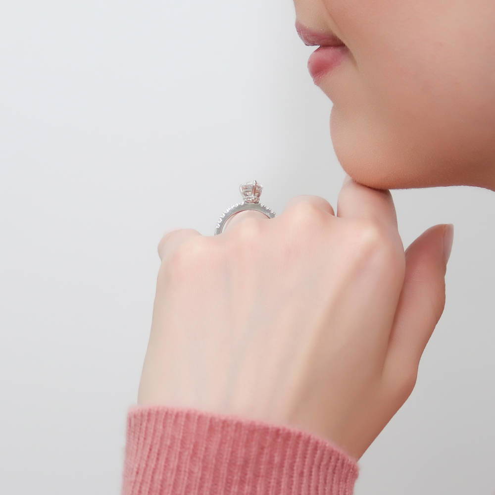 Model wearing Solitaire Hidden Halo 1.8ct Pear CZ Ring Set in Sterling Silver, 10 of 13