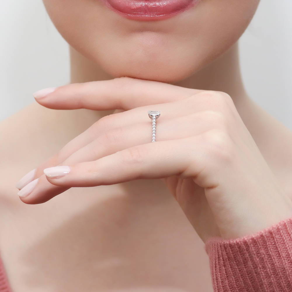 Model wearing Solitaire 0.3ct Emerald Cut CZ Ring in Sterling Silver, 6 of 9