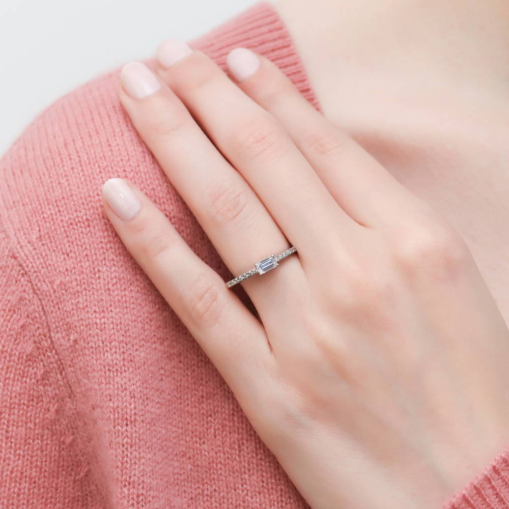 Model wearing Solitaire East-West 0.3ct Emerald Cut CZ Ring in Sterling Silver, 2 of 9